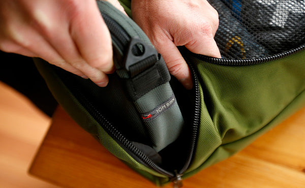 A person removing the Side Kick from the side pocket of an Aeronaut.